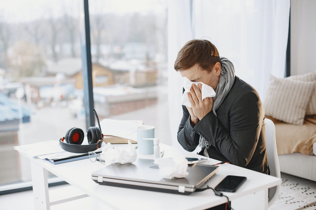 Man sneezing because of allergies